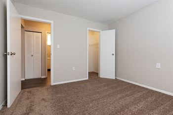 Carpeted Bedroom with Attached Walk-In Closet